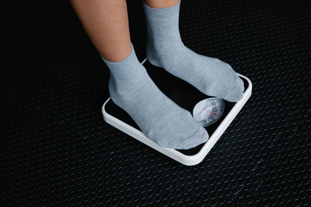 legs in socks standing on scale
